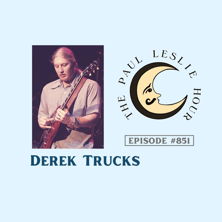 Slide guitarist Derek Trucks is pictured on a light blue background.
